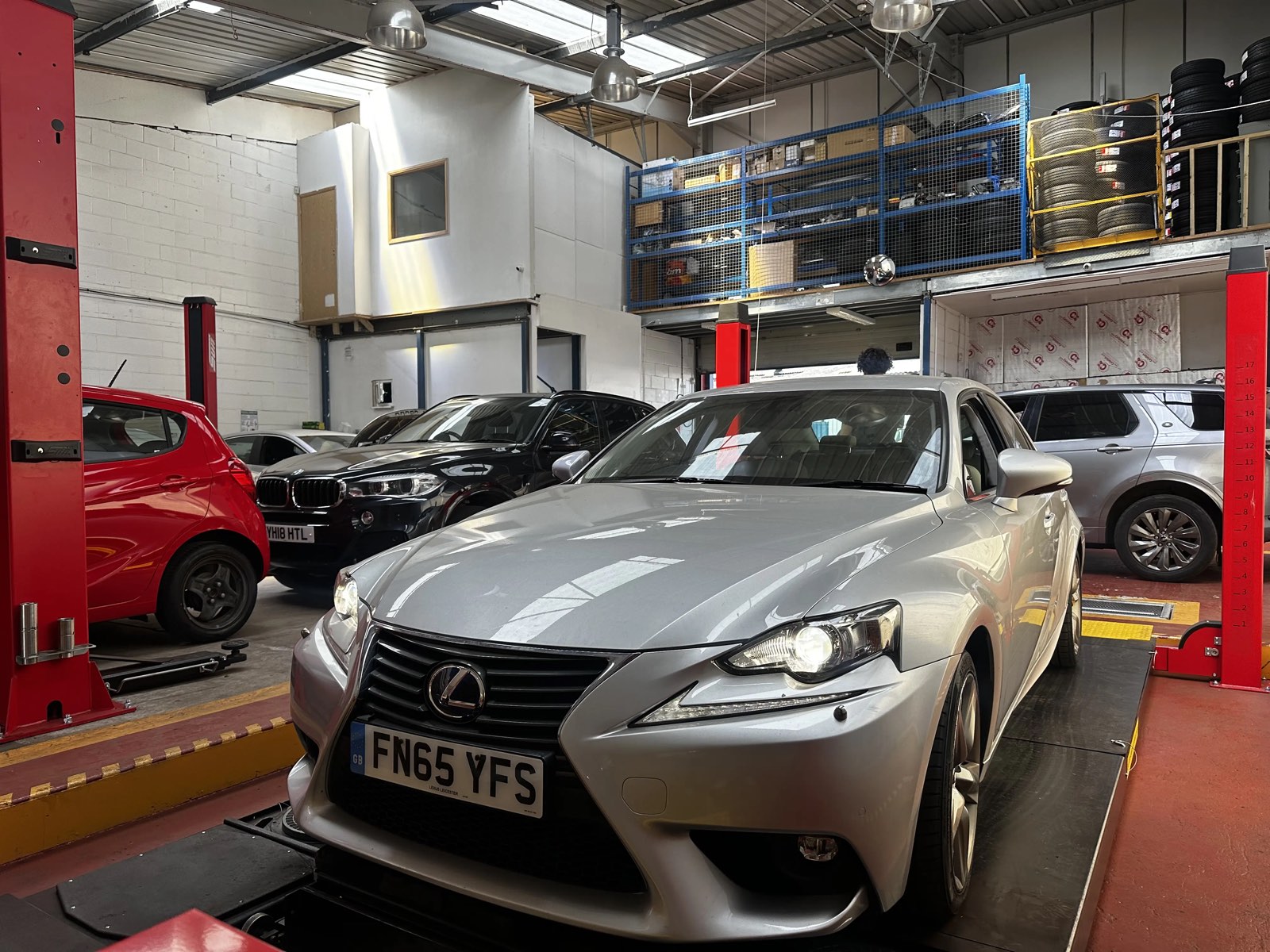 Cars on ramps inside the Surbiton Auto Services workshop
